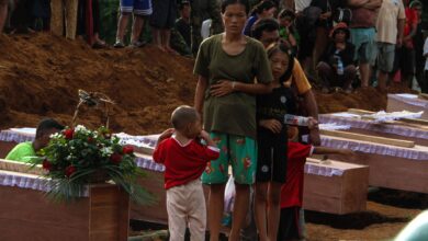 Woman and children at a funeral for victims of a junta airstrike on a camp for displaced people in Laiza, Kachin State in October 2023 (AFP)