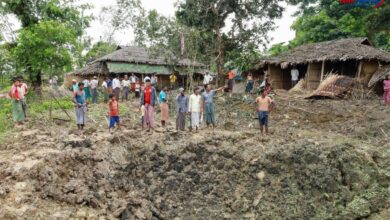 Residents of Kyet Mauk Taung stand around a crater created by a junta airstrike on the village on July 1 (Photo: One Nation News)